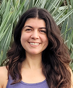 A picture of Krystal Renta in front of palm fronds